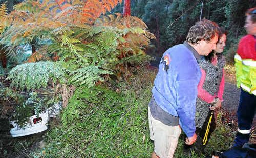 The sedan’s rear was all that was visible after it plunged off an embankment. The sedan’s rear was all that was visible after it plunged off an embankment.