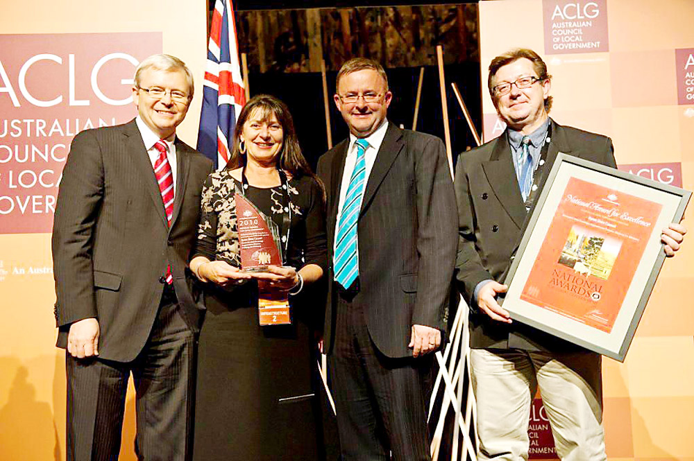 Byron Shire Council mayor Cr Jan Barham and council’s environmental officer Michael Bingham (right) accept the Local Government award from former Prime Minister Kevin Rudd and Anthony Albanese MP. Byron Shire Council mayor Cr Jan Barham and council’s environmental officer Michael Bingham (right) accept the Local Government award from former Prime Minister Kevin Rudd and Anthony Albanese MP.