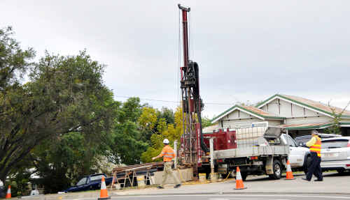 Energex contract workers drill test holes along the proposed power line route. Energex contract workers drill test holes along the proposed power line route.