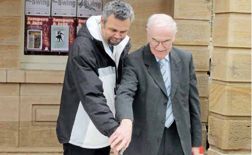 Darryl Charles and Mayor Ron Bellingham cut the cake to commemorate NAIDOC Week. Darryl Charles and Mayor Ron Bellingham cut the cake to commemorate NAIDOC Week.