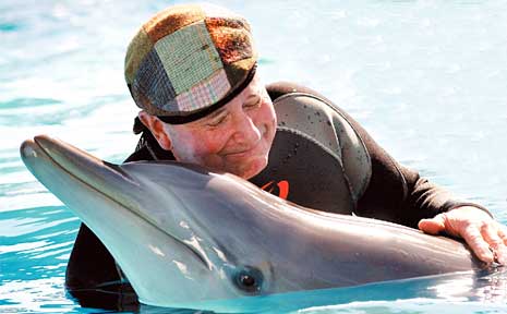 Dr Harry Cooper swimming with Bella at the Pet Porpoise Pool in Coffs Harbour. Dr Harry Cooper swimming with Bella at the Pet Porpoise Pool in Coffs Harbour.