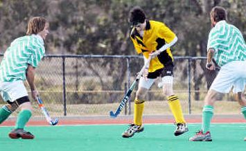 Jesse Ollerton (centre), of Corinthians, goes on the attack against Wyverns in men’s hockey. Jesse Ollerton (centre), of Corinthians, goes on the attack against Wyverns in men’s hockey.