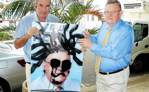 Hinkler campaign manager Rod Wilson and Federal Member Paul Neville with one of the signs. Hinkler campaign manager Rod Wilson and Federal Member Paul Neville with one of the signs.