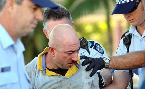 Police take a man into custody after a fight in Mooloolaba yesterday morning. The man had one of his fingers almost bitten off. Police take a man into custody after a fight in Mooloolaba yesterday morning. The man had one of his fingers almost bitten off.