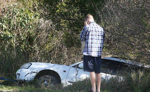 A sedan stuck down an embankment. A sedan stuck down an embankment.