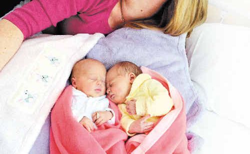 Twins Ava Lillian (left) and Josie Evelyn, pictured with parents Sandra and Ben Litchfield from Woodburn, were born on different days, with Josie arriving at 11.54pm on the 25th August, and Ava arriving at 12.21 on the 26th of August. Ava holds a ring with twin diamond bands given to Sandra from her husband Ben. 28th August 2010. Twins Ava Lillian (left) and Josie Evelyn, pictured with parents Sandra and Ben Litchfield from Woodburn, were born on different days, with Josie arriving at 11.54pm on the 25th August, and Ava arriving at 12.21 on the 26th of August. Ava holds a ring with twin diamond bands given to Sandra from her husband Ben. 28th August 2010.