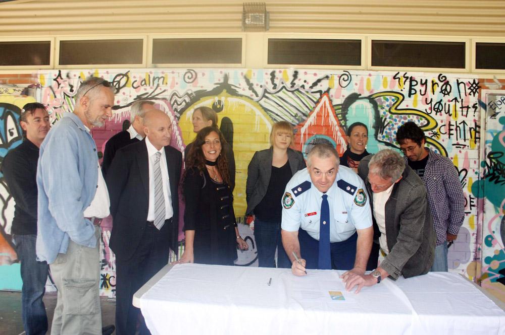 Inspector Owen King from Byron Bay police signs the Schoolies joint vision statement. He is surrounded by other key stakeholders. Inspector Owen King from Byron Bay police signs the Schoolies joint vision statement. He is surrounded by other key stakeholders.