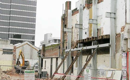 City buildings crumble from the force of the 7.1 magnitude quake. City buildings crumble from the force of the 7.1 magnitude quake.