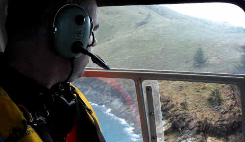 Mackay SES officer-in-charge Justin Englert in the RACQ-CQ Rescue helicopter searches St Bees Island. Mackay SES officer-in-charge Justin Englert in the RACQ-CQ Rescue helicopter searches St Bees Island.