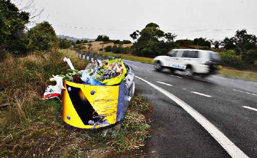 A mangled Give Way sign at the entrance to Woodford Lane, the result of a previous accident, is adorned with flowers left by friends at the scene of Thursday night’s fatal crash that took the lives of Todd Hepner, Jarah Blackett and Byron Nicholson. A mangled Give Way sign at the entrance to Woodford Lane, the result of a previous accident, is adorned with flowers left by friends at the scene of Thursday night’s fatal crash that took the lives of Todd Hepner, Jarah Blackett and Byron Nicholson.