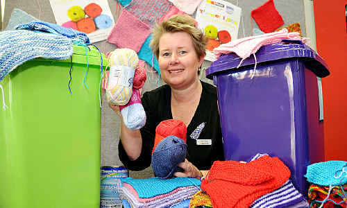 Terri Handy from LJ Hooker displays knitting squares for the Little Haven fundraiser. Terri Handy from LJ Hooker displays knitting squares for the Little Haven fundraiser.