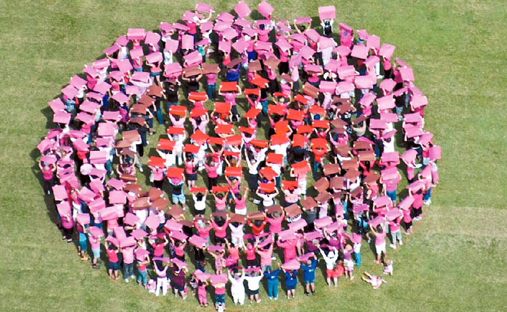 Hundreds of placard-carrying community member stand in formation at the showgrounds to create Mackay's Big Boob as part of a Cancer Council Queensland initiative aimed to raise awareness of breast cancer. Hundreds of placard-carrying community member stand in formation at the showgrounds to create Mackay's Big Boob as part of a Cancer Council Queensland initiative aimed to raise awareness of breast cancer.
