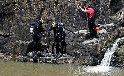 Grim mission: Police divers prepare to enter the water on Sunday at Hanging Rock Falls near Wadeville, north of Kyogle, to search for missing Queensland teenager Mackenzie Mello. They found his body a short time later. Grim mission: Police divers prepare to enter the water on Sunday at Hanging Rock Falls near Wadeville, north of Kyogle, to search for missing Queensland teenager Mackenzie Mello. They found his body a short time later.