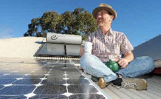 Solar impact: Environmental consultant Gordon Fraser-Quick enjoys a cuppa on the solar panelled roof of his south Lismore home. Solar impact: Environmental consultant Gordon Fraser-Quick enjoys a cuppa on the solar panelled roof of his south Lismore home.