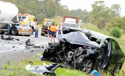 The driver of a crumpled Ford is fighting for her life in Royal Brisbane Hospital after colliding head-on with a B-Double at the site of a road side memorial for Rachel Purdy and Corey Whitmore, two of the victims of a triple fatality on September 4, 2008. The driver of a crumpled Ford is fighting for her life in Royal Brisbane Hospital after colliding head-on with a B-Double at the site of a road side memorial for Rachel Purdy and Corey Whitmore, two of the victims of a triple fatality on September 4, 2008.
