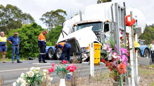 Flowers mark the place where four people died on the Bruce Highway in 2008, just metres from yesterday’s crash between a Ford and a B-Double (pictured). Flowers mark the place where four people died on the Bruce Highway in 2008, just metres from yesterday’s crash between a Ford and a B-Double (pictured).