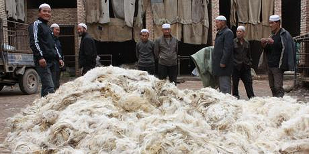 Hui men selling wool at a village market in China. Hui men selling wool at a village market in China.