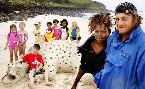 Sand sculpture artists Jessie Ara and Dan Eyles, of Byron Bay, at Sharps Beach with the dragon they created for children from the C3 Church in Ballina for the church’s family activity day. Sand sculpture artists Jessie Ara and Dan Eyles, of Byron Bay, at Sharps Beach with the dragon they created for children from the C3 Church in Ballina for the church’s family activity day.