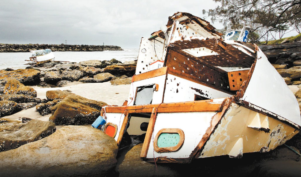 The shattered wreckage of a yacht litters the south side of Shark Bay at Evans Head after it struck the southern breakwall. The yacht's Tweed Heads skipper miraculously survived the dramatic incident, despite being washed overboard. The shattered wreckage of a yacht litters the south side of Shark Bay at Evans Head after it struck the southern breakwall. The yacht's Tweed Heads skipper miraculously survived the dramatic incident, despite being washed overboard.