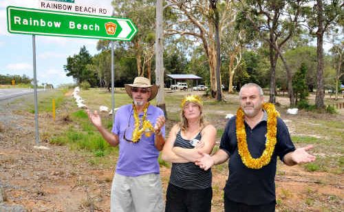 Rainbow Beach Lions Club members Murray Johnston and Angela and Rex Bright are devastated by the disappearance of their annual Christmas Parade banner (right) which was removed by the Main Roads Department.