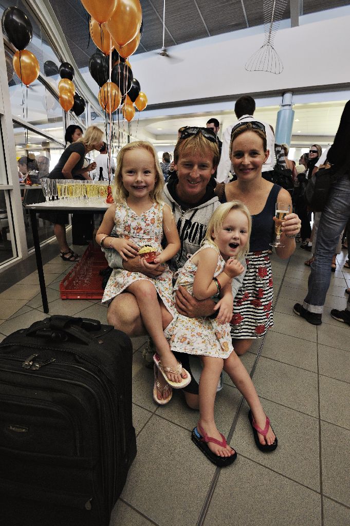 Anna Platt from Lennox Head and daughters Claudia, 5, and Jacqui, 4, welcome home dad Vaughan Platt as he disembarks from the first plane to land at Ballina Byron Airport on the new Melbourne service.