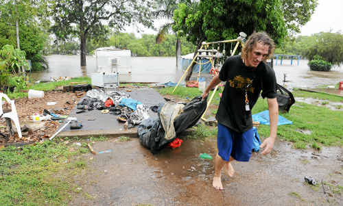 Jason Baas helps remove belongings from a site at the Riverdale Caravan Park, Bundaberg North. Jason Baas helps remove belongings from a site at the Riverdale Caravan Park, Bundaberg North.