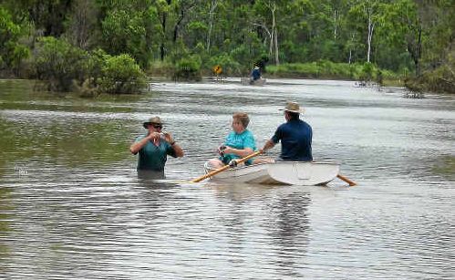 Frank McKee, in the water, of the southern end of Monto Road meets Albert and Judy Spencer (in boat) from the northern end of the road during Thursday’s “party” meeting. Frank McKee, in the water, of the southern end of Monto Road meets Albert and Judy Spencer (in boat) from the northern end of the road during Thursday’s “party” meeting.