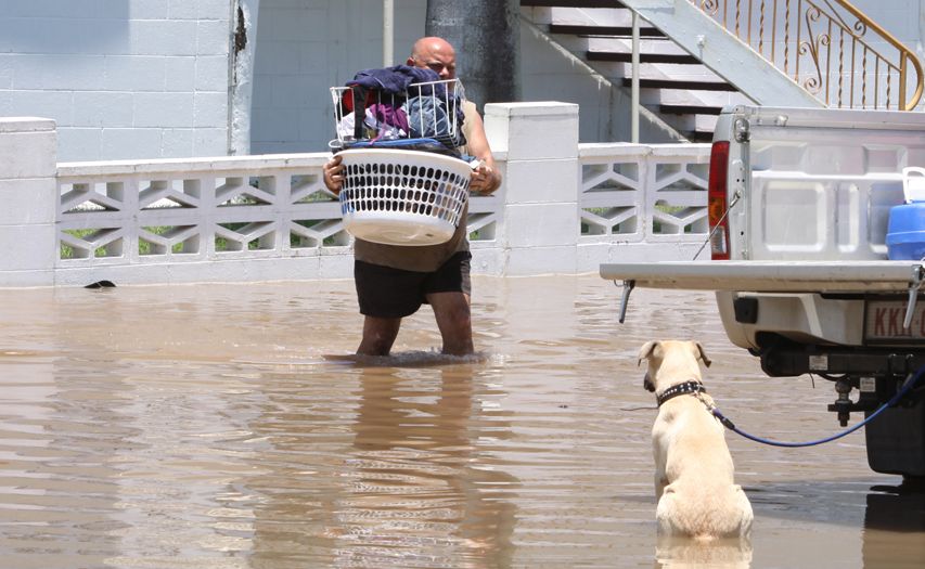 A man packs his belongings into the back of a ute during the floods in Rockhampton. A man packs his belongings into the back of a ute during the floods in Rockhampton.