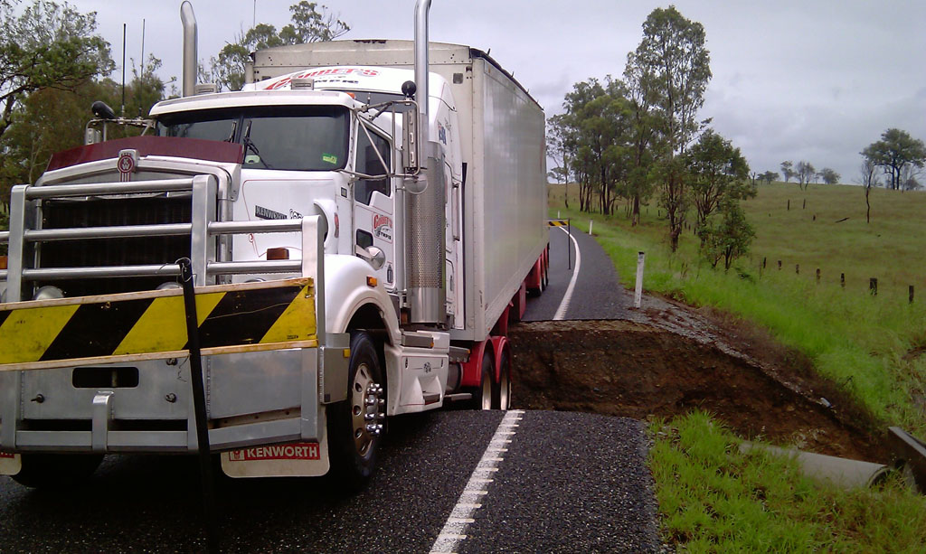 Corbets transport truck stuck on Wide Bay Highway north-west of Gympie, after the road gave way under the vehicle near Serpentine Creek. Corbets transport truck stuck on Wide Bay Highway north-west of Gympie, after the road gave way under the vehicle near Serpentine Creek.