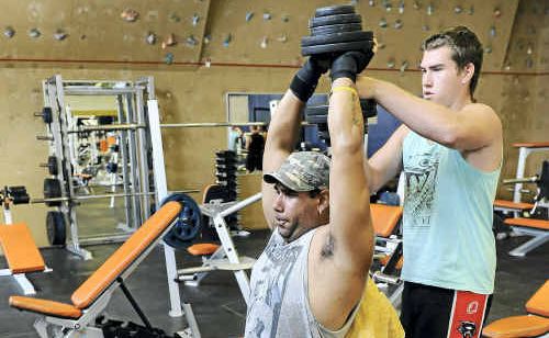 Ian Ell spots for Joel Tanna in the gym during a weights session. Ian Ell spots for Joel Tanna in the gym during a weights session.