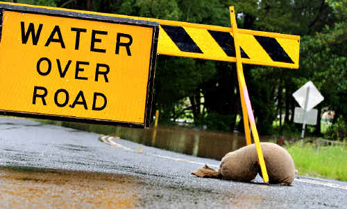 Watery end: Flooding cuts the road to Chillingham after days of warnings. Watery end: Flooding cuts the road to Chillingham after days of warnings.