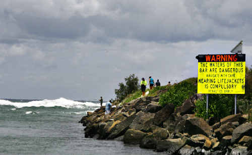 Dangerous waters: A sign warns boat owners of possible dangerous conditions ahead at the Brunswick bar. Dangerous waters: A sign warns boat owners of possible dangerous conditions ahead at the Brunswick bar.