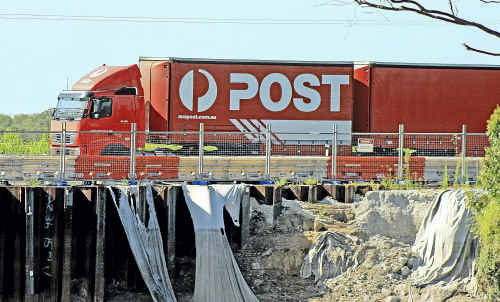 A view of the Pacific Highway near Shark Creek where protective cloth on a section that has previously slipped into the river has decayed. A view of the Pacific Highway near Shark Creek where protective cloth on a section that has previously slipped into the river has decayed.