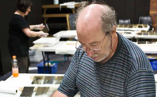 Sandy Barrie washes a glass plate negatives. Sandy Barrie washes a glass plate negatives.