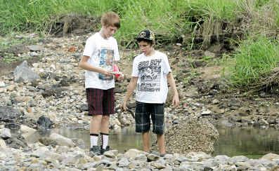 Shane Thomson, 13, and Dylan Roberts, 12, search along the Dee River looking for treasures; this time they found an old hand grenade from World War II. Shane Thomson, 13, and Dylan Roberts, 12, search along the Dee River looking for treasures; this time they found an old hand grenade from World War II.