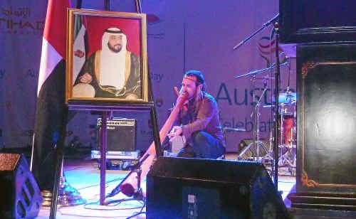 Coffs Coast didgeridoo player Kristian Benton performs under a portrait of Sheikh Zayed the ruler of Abu Dhabi. Coffs Coast didgeridoo player Kristian Benton performs under a portrait of Sheikh Zayed the ruler of Abu Dhabi.