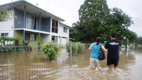 Residents heading home through floodwaters on Mill Street, Goodna. Residents heading home through floodwaters on Mill Street, Goodna.