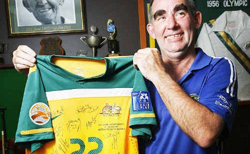 Jon Kitching with a signed Australian soccer shirt, being auctioned for flood victims. Jon Kitching with a signed Australian soccer shirt, being auctioned for flood victims.