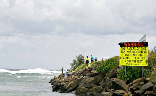 A sign on the rockwall at the entrance to the Brunswick Heads bar warns boat owners of possible dangerous conditions ahead. A sign on the rockwall at the entrance to the Brunswick Heads bar warns boat owners of possible dangerous conditions ahead.