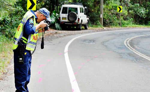 Det Snr Const Gary Kennedy, of the Lismore Crime Scene Unit, takes photographs at the scene of Saturday night’s fatal crash on Broken Head Road, which claimed the life of a 19-year-old Ballina woman. Det Snr Const Gary Kennedy, of the Lismore Crime Scene Unit, takes photographs at the scene of Saturday night’s fatal crash on Broken Head Road, which claimed the life of a 19-year-old Ballina woman.