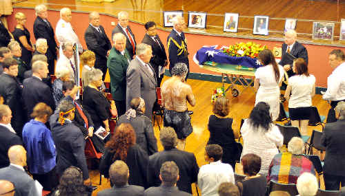 The scene inside the Armidale Town Hall yesterday when 400 people gathered for the State funeral of former Lismore boxer Frank Roberts. Hundreds of others sat or stood outside in the street. The stage area had a backdrop of the Aboriginal flag and a large projected image of Roberts, while family photographs were arrayed along the front. The casket was draped in the Australian and Olympic flags and the boxing belt awarded to Roberts for his achievements in the sport. The scene inside the Armidale Town Hall yesterday when 400 people gathered for the State funeral of former Lismore boxer Frank Roberts. Hundreds of others sat or stood outside in the street. The stage area had a backdrop of the Aboriginal flag and a large projected image of Roberts, while family photographs were arrayed along the front. The casket was draped in the Australian and Olympic flags and the boxing belt awarded to Roberts for his achievements in the sport.