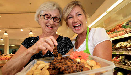 Kim McCosker gives Laurel Hanna a piece of her ginger fruit cake to try. Kim McCosker gives Laurel Hanna a piece of her ginger fruit cake to try.