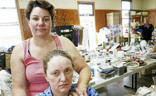Volunteers Kerry Holloway and Kelli Smith (front) at the Redbank flood donation centre. Volunteers Kerry Holloway and Kelli Smith (front) at the Redbank flood donation centre.