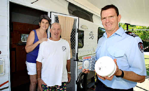 Senior firefighter Mark Whiticker explains new laws relating to smoke alarms in caravans to Carolyn Turney and Stephen. Senior firefighter Mark Whiticker explains new laws relating to smoke alarms in caravans to Carolyn Turney and Stephen.