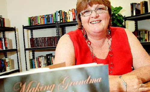 Author Jacki Scott with one of her books, donated to the RSL Care. Author Jacki Scott with one of her books, donated to the RSL Care.