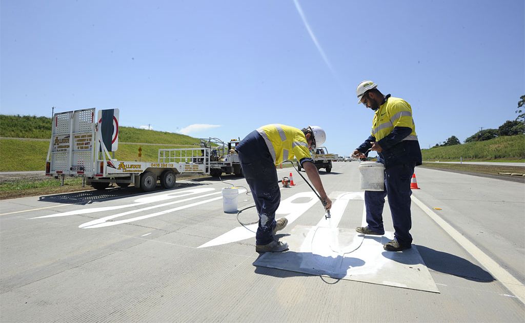 Aaron Lancaster (left) and Milton Berghan from Allstate Linemarking put the finishing touches to the speed markings on the road surface of the northern section of the Ballina Bypass. Aaron Lancaster (left) and Milton Berghan from Allstate Linemarking put the finishing touches to the speed markings on the road surface of the northern section of the Ballina Bypass.