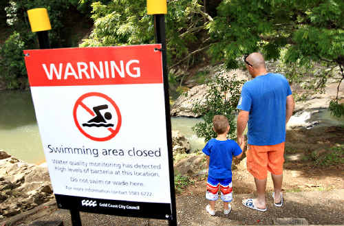 NO SWIMMING: Heath Cameron and his son Mason were not able to swim in the Currumbin Rock Pools. NO SWIMMING: Heath Cameron and his son Mason were not able to swim in the Currumbin Rock Pools.