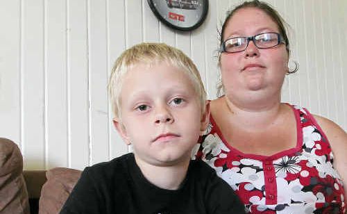 Heidi Carter keeps a close watch over her son Lochlan Winkelmann, 8, yesterday who suffered breaks to both arms after an incident in the school playground. Heidi Carter keeps a close watch over her son Lochlan Winkelmann, 8, yesterday who suffered breaks to both arms after an incident in the school playground.