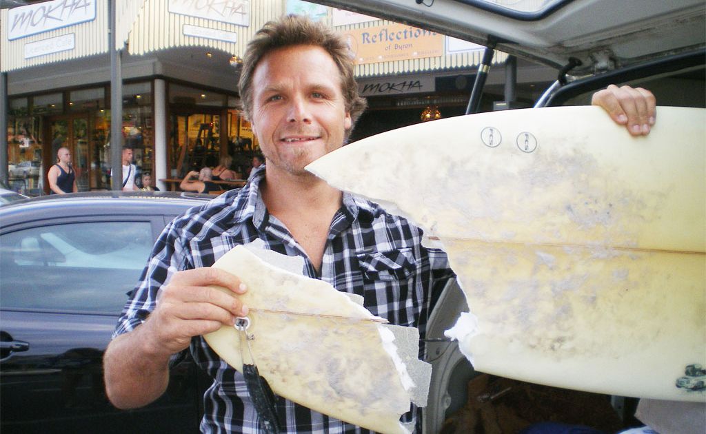 Byron Bay man Prem Puri may have been hit by a shark while surfing at Tallow Beach last week. The local musician and small businessman was knocked suddenly from his board while riding a wave in open water about 100 metres south of the lighthouse about 1pm last Thursday. He is pictured here with the remains of his surfboard. Byron Bay man Prem Puri may have been hit by a shark while surfing at Tallow Beach last week. The local musician and small businessman was knocked suddenly from his board while riding a wave in open water about 100 metres south of the lighthouse about 1pm last Thursday. He is pictured here with the remains of his surfboard.