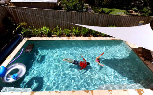 A backyard swimming pool. A backyard swimming pool.